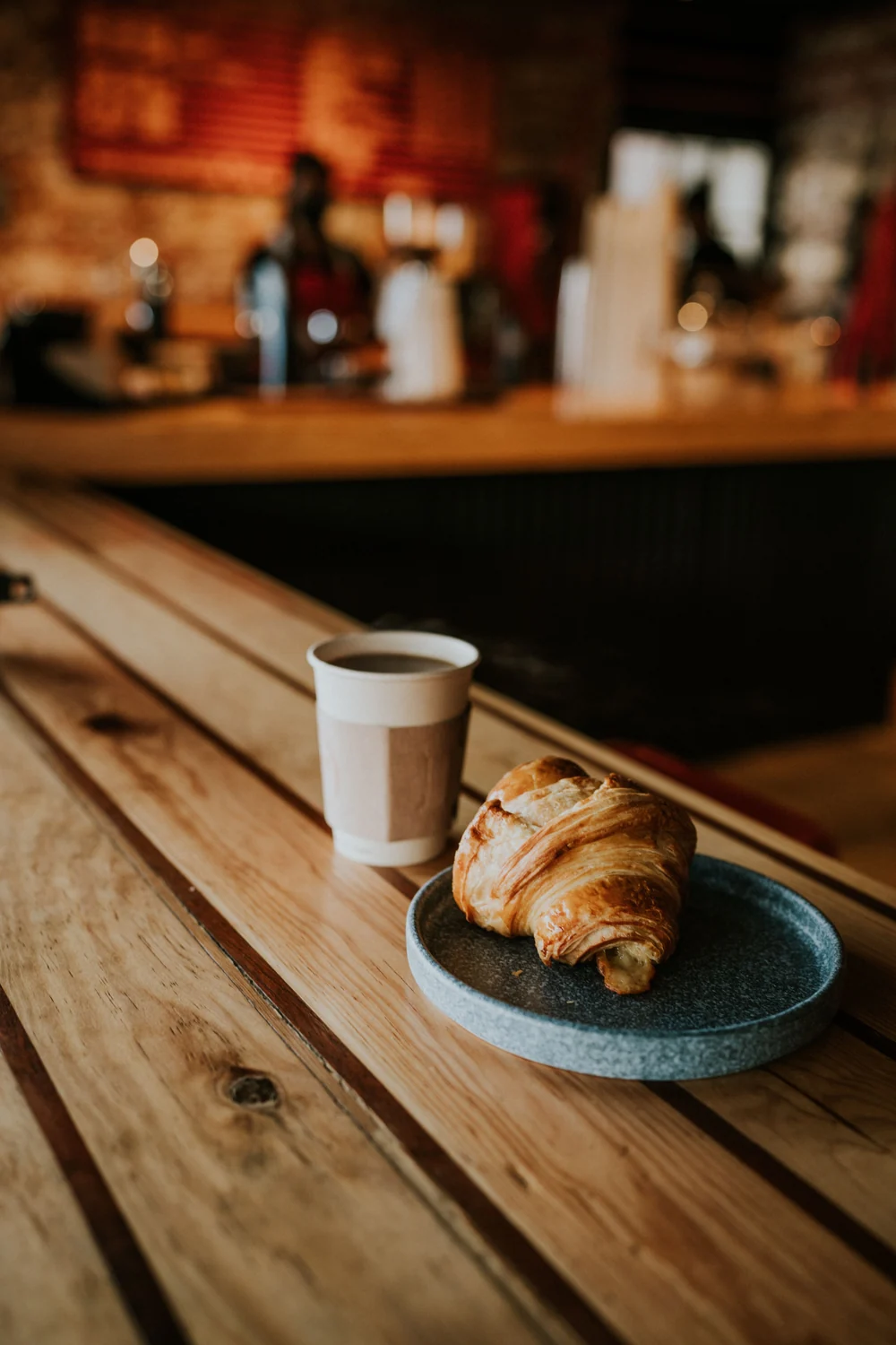 Coffee and a croissant at a café; illustrative lifestyle photography